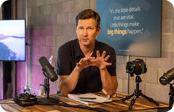 Murphy talking around podcast equipment